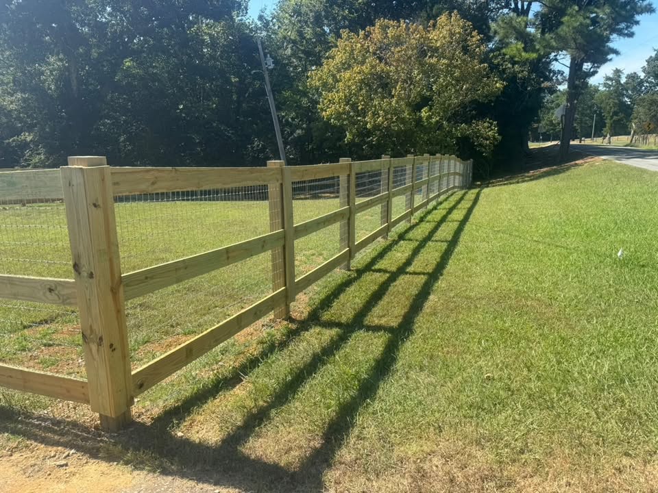 Wood rail fence with wire built by Integrity Fence and Outdoor